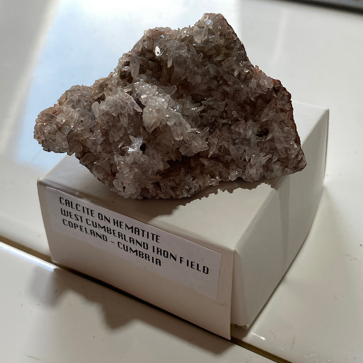 CALCITE ON HEMATITE : WEST CUMBERLAND IRON FIELD, COPELAND, CUMBRIA. 57g MF5354