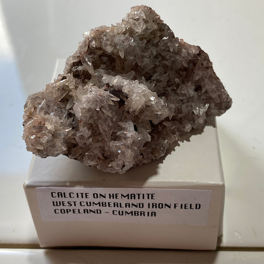 CALCITE ON HEMATITE : WEST CUMBERLAND IRON FIELD, COPELAND, CUMBRIA. 57g MF5354